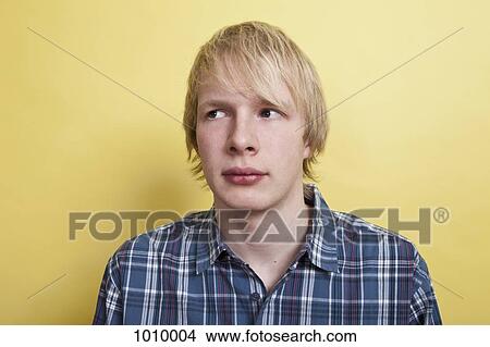 A teenage boy looking off to the side with curiosity, portrait, studio shot View Large Photo Image Picture - A teenage boy looking off to the side with curiosity, portrait, studio shot. Fotosearch
