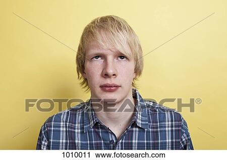 A teenage boy looking up, portrait, studio shot View Large Photo Image Stock Image - A teenage boy looking up, portrait, studio shot. Fotosearch
