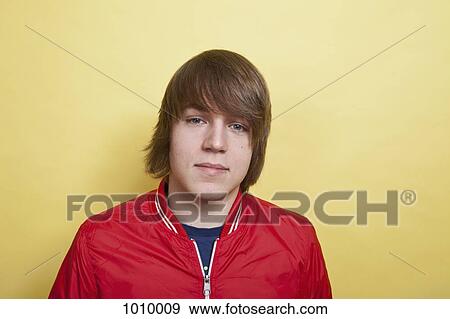 Stock Photo - A teenage boy, portrait, studio shot. Fotosearch