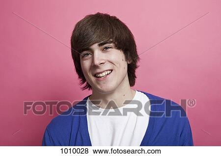 A teenage boy smiling, portrait, studio shot View Large Photo Image Stock Photo - A teenage boy smiling, portrait, studio shot. Fotosearch