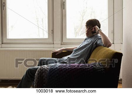 A teenage boy using a mobile phone View Large Photo Image Stock Photo - A teenage boy using a mobile phone. Fotosearch