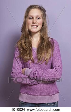A teenage girl biting her lip, portrait, studio shot View Large Photo Image Picture - A teenage girl biting her lip, portrait, studio shot. Fotosearch