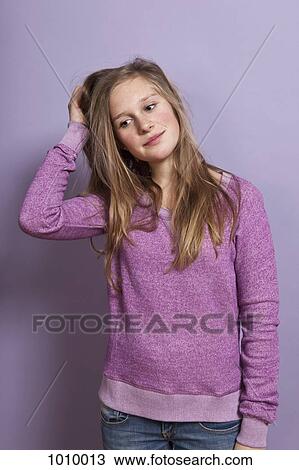 A teenage girl scratching her head View Large Photo Image Stock Image - A teenage girl scratching her head. Fotosearch