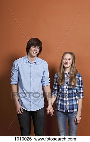 A teenage, heterosexual couple, portrait, studio shot View Large Photo Image Stock Photograph - A teenage, heterosexual couple, portrait, studio shot. Fotosearch