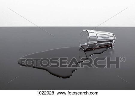 A tipped over glass of red juice View Large Photo Image Stock Photo - A tipped over glass of red juice. Fotosearch
