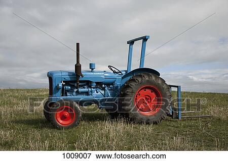 A tractor in a field View Large Photo Image Stock Photo - A tractor in a field. Fotosearch