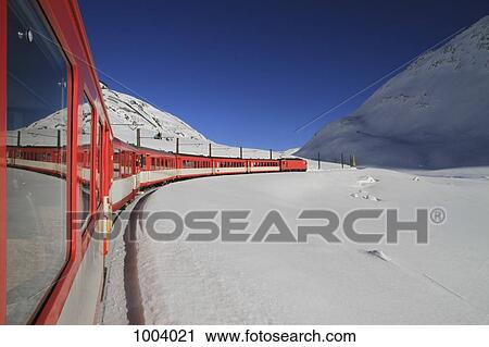Stock Image - A train traveling through Oberalp Pass, Andermatt, Uri Canton, Switzerland. Fotosearch