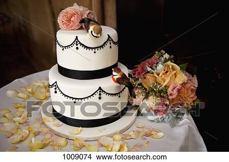 A wedding cake decorated with flowers and birds View Large Photo Image Picture - A wedding cake decorated with flowers and birds. Fotosearch