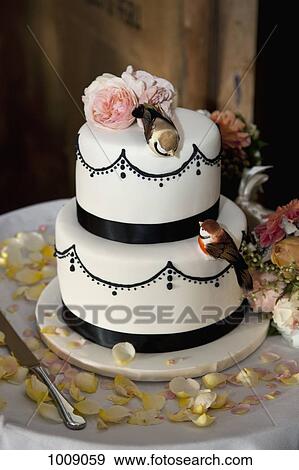 A wedding cake decorated with flowers and birds View Large Photo Image Stock Photo - A wedding cake decorated with flowers and birds. Fotosearch