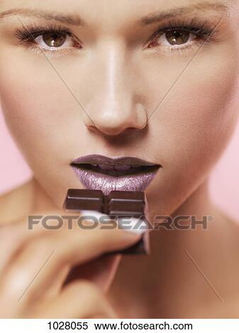 A woman about to eat a chocolate bar View Large Photo Image Stock Photography - A woman about to eat a chocolate bar. Fotosearch