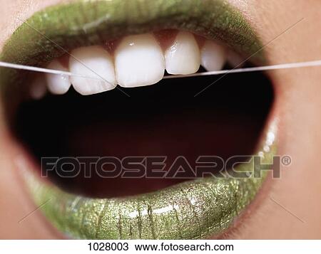 A woman flossing her teeth, extreme close up of mouth View Large Photo Image Stock Image - A woman flossing her teeth, extreme close up of mouth. Fotosearch