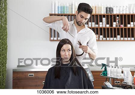 A woman having her hair cut by a male hairdresser View Large Photo Image Stock Photograph - A woman having her hair cut by a male hairdresser. Fotosearch