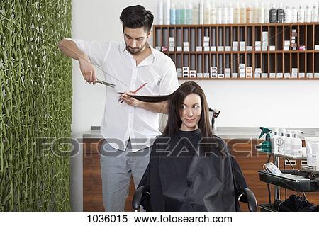 A woman having her hair cut by a male hairdresser View Large Photo Image Stock Photography - A woman having her hair cut by a male hairdresser. Fotosearch
