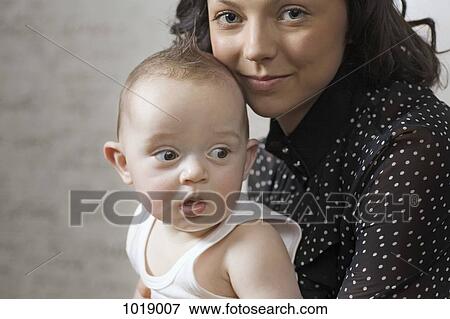 A woman holding her baby boy View Large Photo Image Stock Photo - A woman holding her baby boy. Fotosearch