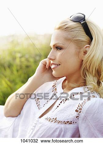 A woman in nature using a mobile phone View Large Photo Image Stock Image - A woman in nature using a mobile phone . Fotosearch