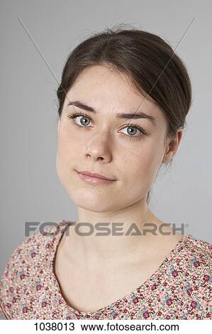Stock Image - A woman looking serenely into the camera. Fotosearch
