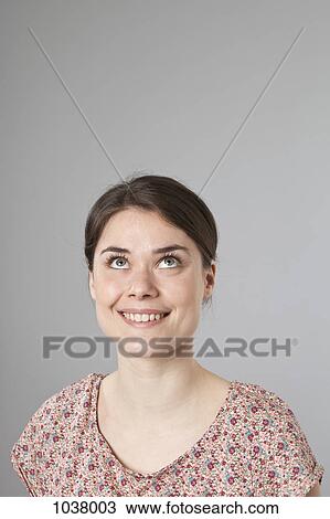 A woman looking up excitedly, portrait View Large Photo Image Stock Image - A woman looking up excitedly, portrait. Fotosearch