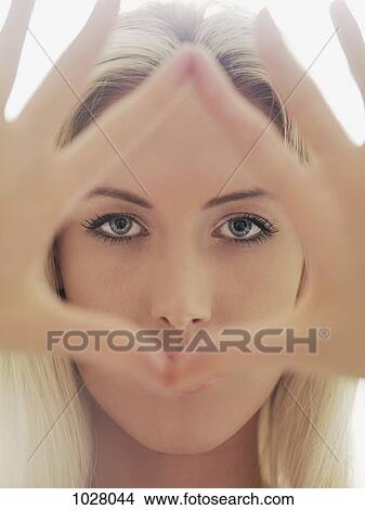 A woman making a triangular shape with her fingers View Large Photo Image Picture - A woman making a triangular shape with her fingers. Fotosearch