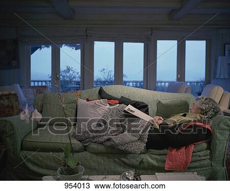 A woman napping on a sofa View Large Photo Image Stock Image - A woman napping on a sofa. Fotosearch