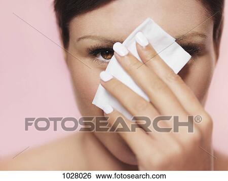 A woman peeking from behind a tissue View Large Photo Image Stock Photograph - A woman peeking from behind a tissue. Fotosearch