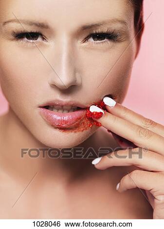 A woman rubbing a smashed raspberry on her face View Large Photo Image Stock Photograph - A woman rubbing a smashed raspberry on her face. Fotosearch
