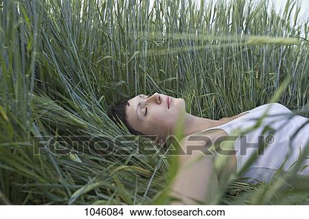A woman sleeping in grass View Large Photo Image Picture - A woman sleeping in grass. Fotosearch