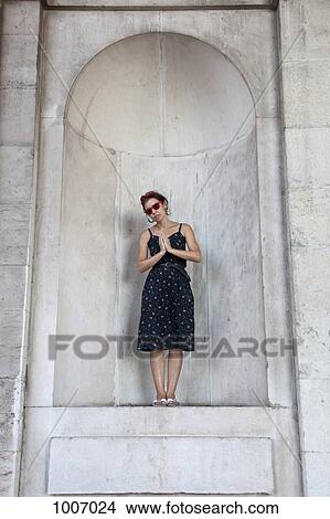 A woman standing in an apse and praying View Large Photo Image Picture - A woman standing in an apse and praying. Fotosearch