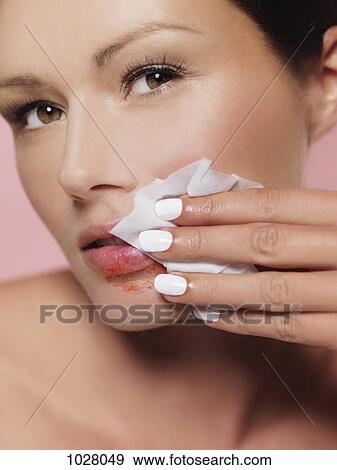 A woman wiping lipstick off with a tissue View Large Photo Image Stock Photo - A woman wiping lipstick off with a tissue. Fotosearch