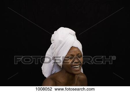 Stock Image - A woman with a towel wrapped on her head. Fotosearch