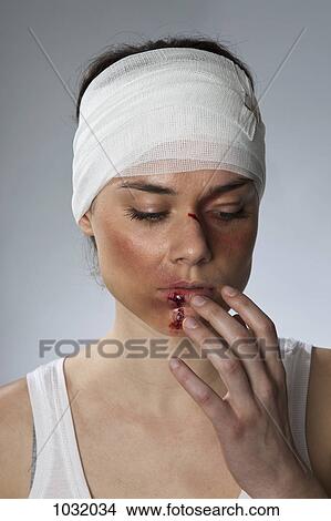 A woman with injuries and a bandaged head View Large Photo Image Picture - A woman with injuries and a bandaged head. Fotosearch