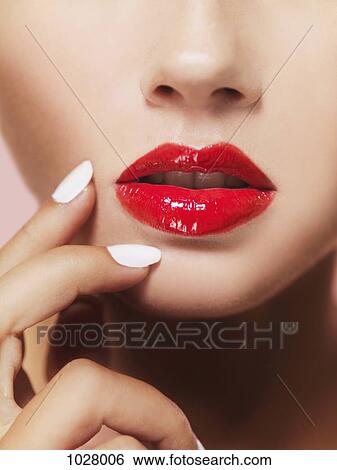 A woman's lips with bright red lipstick, close-up of mouth View Large Photo Image Stock Photograph - A woman's lips with bright red lipstick, close-up of mouth. Fotosearch