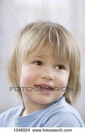 A young boy smiling and looking away View Large Photo Image Picture - A young boy smiling and looking away. Fotosearch
