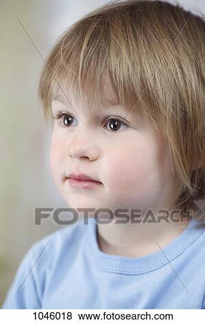 A young boy staring off camera View Large Photo Image Stock Photo - A young boy staring off camera. Fotosearch