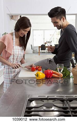 A young couple enjoying cooking together View Large Photo Image Stock Image - A young couple enjoying cooking together. Fotosearch