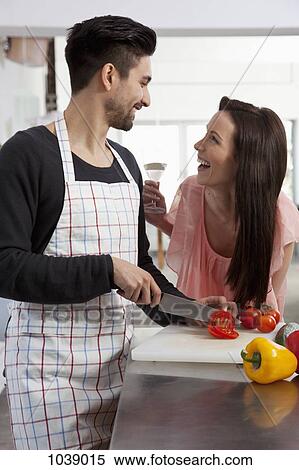 A young couple having fun while cooking View Large Photo Image Stock Photography - A young couple having fun while cooking. Fotosearch