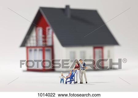 A young family of miniature figurines in front of a house View Large Photo Image Stock Image - A young family of miniature figurines in front of a house. Fotosearch
