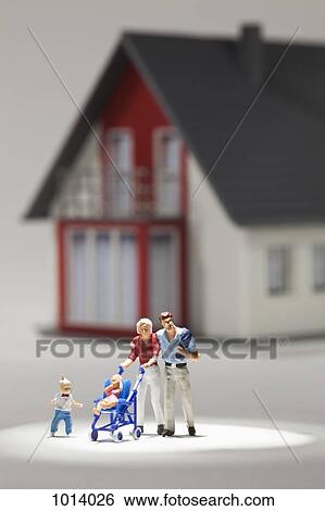 A young family of miniature figurines in front of a house View Large Photo Image Stock Photograph - A young family of miniature figurines in front of a house. Fotosearch