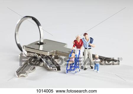A young family of miniature figurines standing next to house keys on a key ring View Large Photo Image Stock Photography - A young family of miniature figurines standing next to house keys on a key ring. Fotosearch