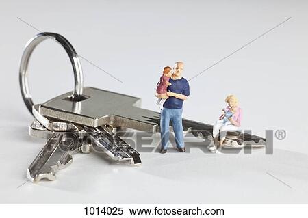 A young family of miniature figurines and house keys on a key ring View Large Photo Image Stock Photography - A young family of miniature figurines and house keys on a key ring. Fotosearch