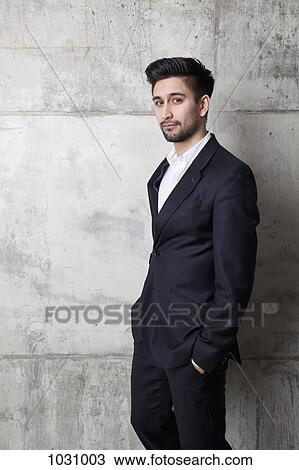 A young hip businessman with his hands in his pockets View Large Photo Image Stock Image - A young hip businessman with his hands in his pockets. Fotosearch