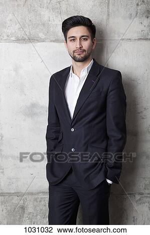 A young hip businessman with his hands in his pockets View Large Photo Image Stock Image - A young hip businessman with his hands in his pockets. Fotosearch
