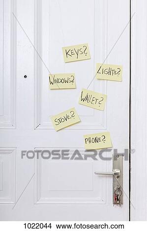 Adhesive notes on a front door with various reminders View Large Photo Image Picture - Adhesive notes on a front door with various reminders . Fotosearch
