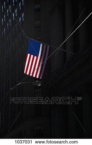 American flag on flagpole attached to shadowed tall building View Large Photo Image Stock Image - American flag on flagpole attached to shadowed tall building. Fotosearch