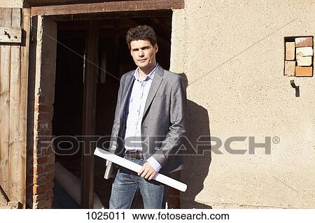An architect standing outside of a building site View Large Photo Image Stock Image - An architect standing outside of a building site. Fotosearch