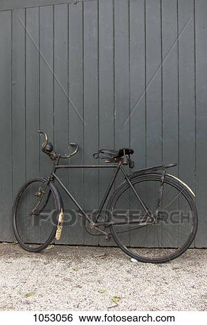 An old bicycle leaning against a wall View Large Photo Image Stock Photograph - An old bicycle leaning against a wall. Fotosearch