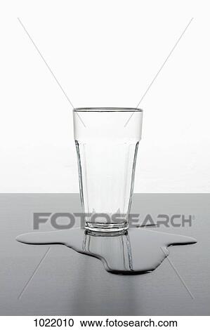 An upright glass standing in a puddle of spilled water View Large Photo Image Stock Image - An upright glass standing in a puddle of spilled water. Fotosearch