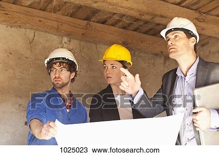 Architects and a building contractor at a building site View Large Photo Image Stock Image - Architects and a building contractor at a building site. Fotosearch