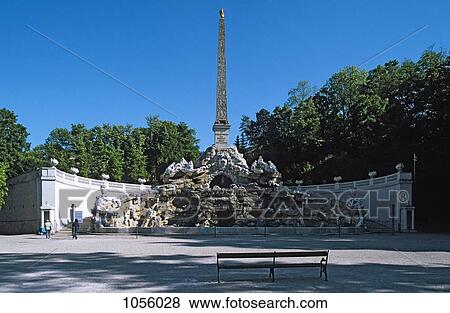 Austria, Vienna, Obelisk fountain at Schonbrunn palace with empty bench in the foreground View Large Photo Image Stock Photo - Austria, Vienna, Obelisk fountain at Schonbrunn palace with empty bench in the foreground. Fotosearch