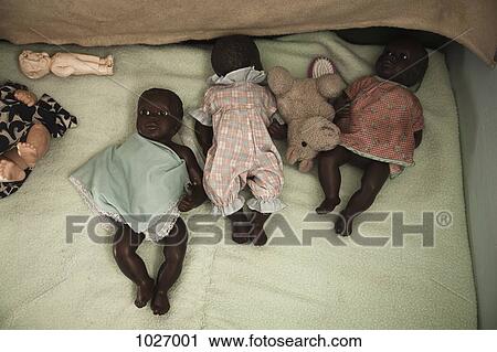 Baby dolls laying on a blanket View Large Photo Image Stock Image - Baby dolls laying on a blanket. Fotosearch