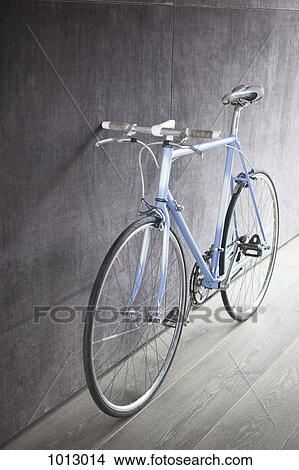 Bicycle leaning against wall. View Large Photo Image Picture - Bicycle leaning against wall.. Fotosearch